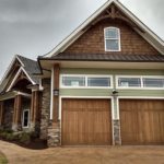 house on hill with garage doors