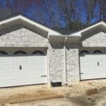 white brick house garage doors